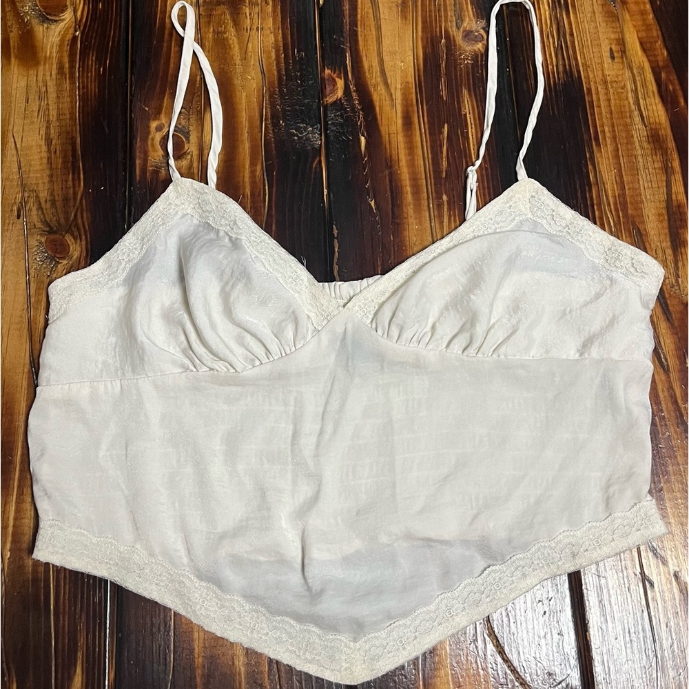 Cute off white cropped tank top with lace accents.
